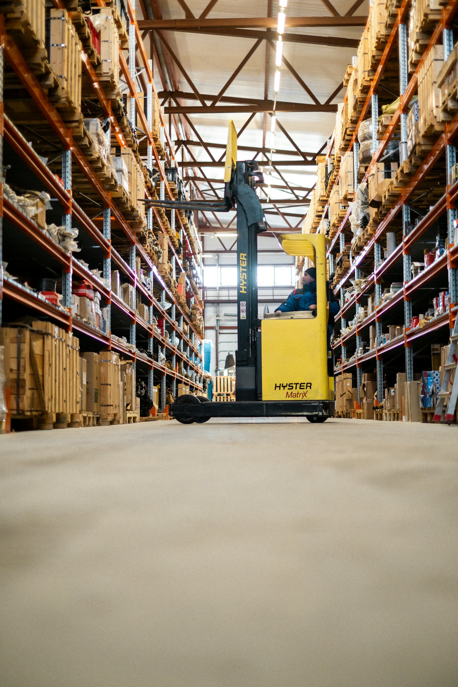 Technician operating handling equipment in a warehouse
